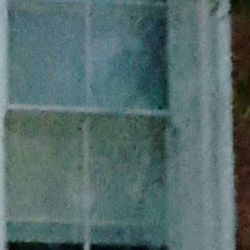 Ghostly figure of a man visible in the top-right window pane of the Tombstone courthouse